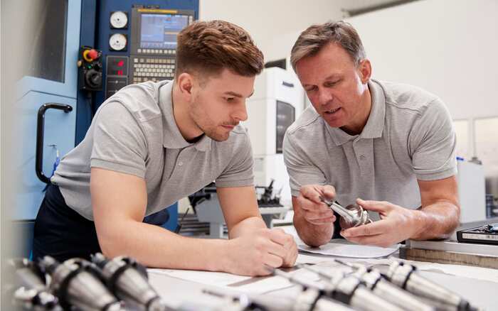 Two engineers reviewing precision aerospace components